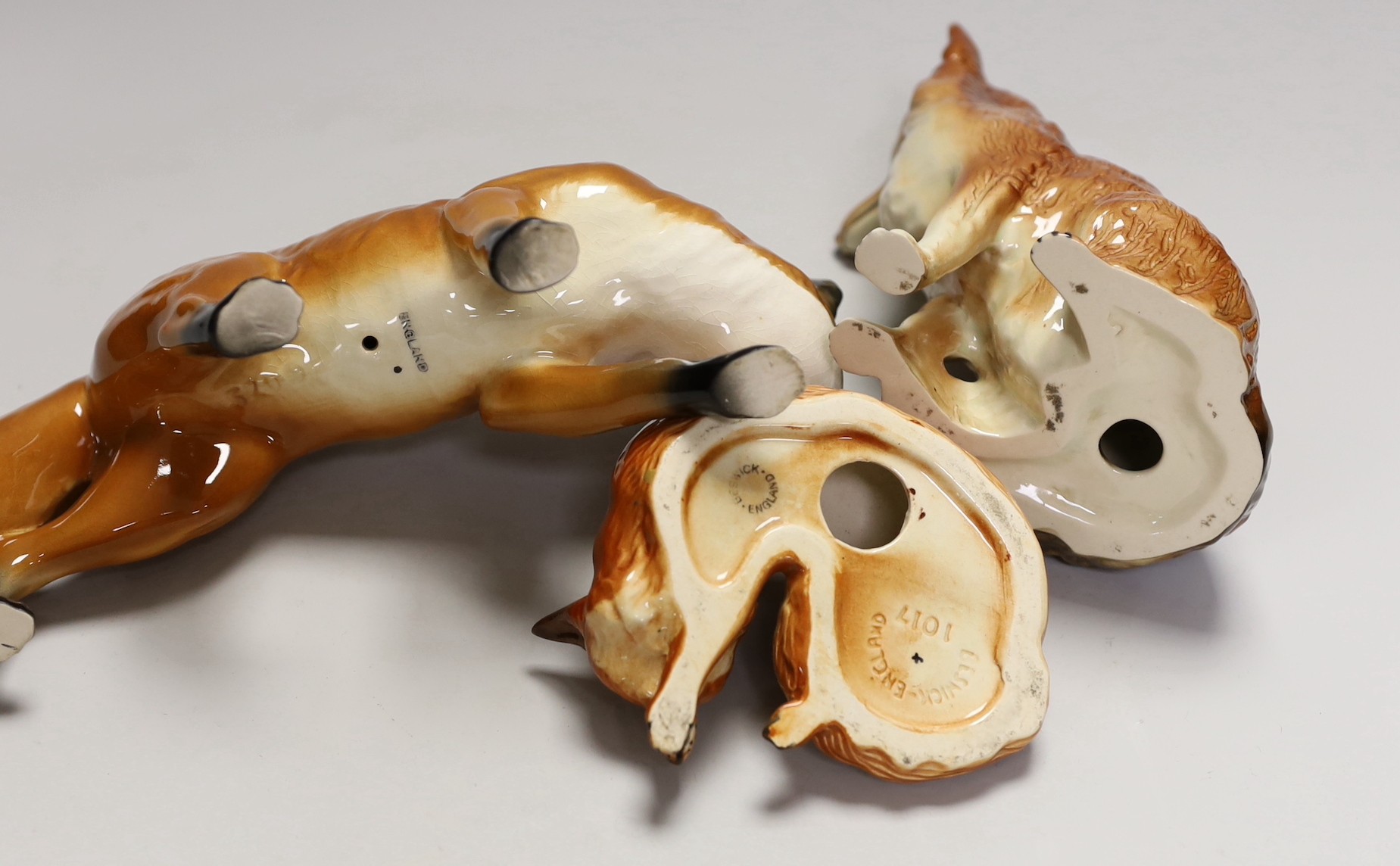 Two Beswick foxes and another